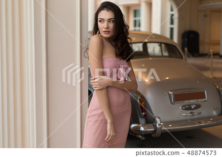 Beautiful woman in a soft pink dress posing. 48874573