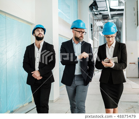 Engineers in hardhats have conversation Engineers in hardhats have conversation 48875479