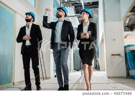 Engineers in hardhats have conversation Engineers in hardhats have conversation 48875486