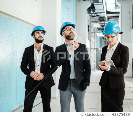 Engineers in hardhats have conversation Engineers in hardhats have conversation 48875489