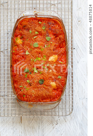 Baked pasta with tomato sauce and mozzarella Baked pasta with tomato sauce and mozzarella 48875814