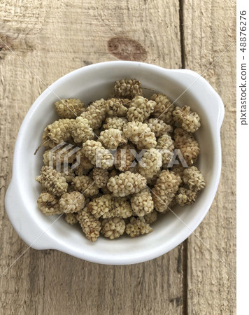 dried mulberry fruits on a wooden table 48876276