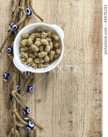 dried mulberry fruits on a wooden table decorated 48876282