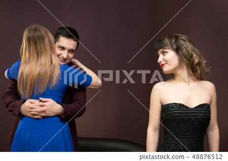 The girl is jealous of a young man to another The girl is jealous of a young man to another 48876512