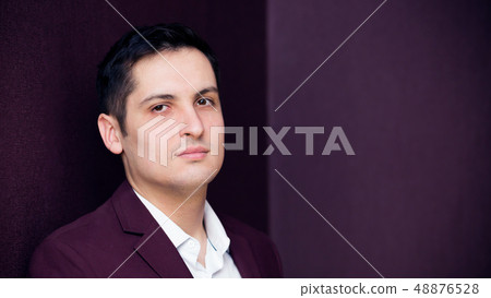 Serious young man on a dark background. 48876528