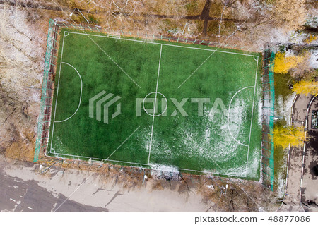 Photo from above of soccer field with snow. 48877086