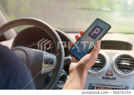 Driver using smartphone app to pay for parking 48878159