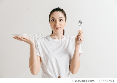 Young fun crazy brunette housewife with spoon isolated on white background Young fun crazy brunette housewife with spoon isolated on white background 48878293