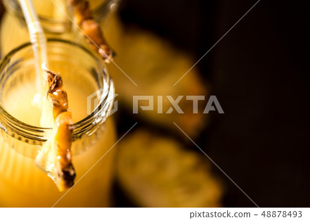 Pineapple juice and slice placed on a wooden table 48878493