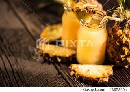 Pineapple juice and slice placed on a wooden table 48878494