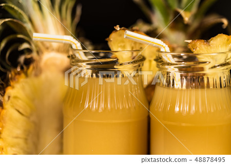 Pineapple juice and slice placed on a wooden table 48878495