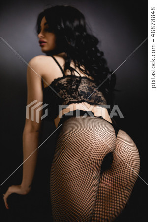 Sexy woman in lace black sensual lingerie and pantyhose with long hair posing in studio. Sexy woman in lace black sensual lingerie and pantyhose with long hair posing in studio. 48878848