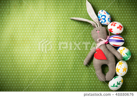 Easter eggs and easter bunny lie on a green background 48880676
