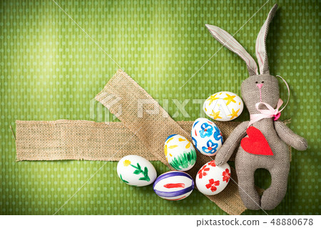 Easter eggs and easter bunny lie on a green background 48880678