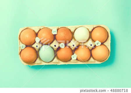 Easter eggs lie in a vintage tray on a blue background Easter eggs lie in a vintage tray on a blue background 48880718