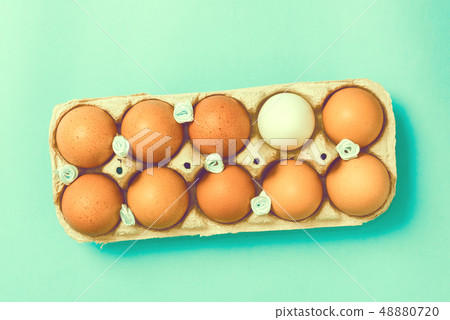Easter eggs lie in a vintage tray on a blue background Easter eggs lie in a vintage tray on a blue background 48880720