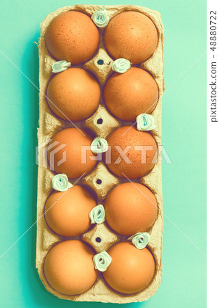 Easter eggs lie in a vintage tray on a blue background 48880722