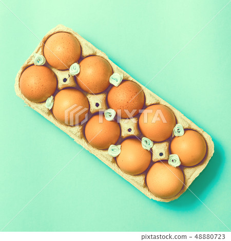 Easter eggs lie in a vintage tray on a blue background Easter eggs lie in a vintage tray on a blue background 48880723