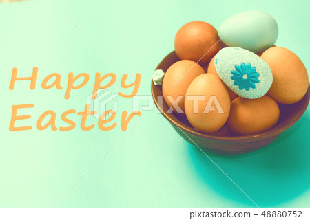 Brown Easter eggs lie in a plate on a blue background Brown Easter eggs lie in a plate on a blue background 48880752