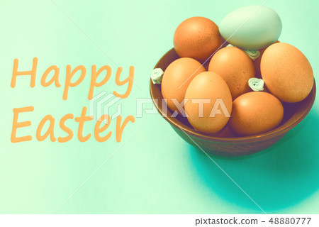 Brown Easter eggs lie in a plate on a blue background Brown Easter eggs lie in a plate on a blue background 48880777