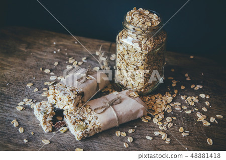 Homemade Granola with Nut Mix In Jar on wooden board on stone table background. Healthy Food Concept 48881418