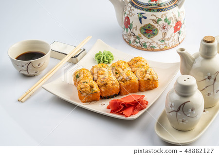 Baked rolls with scallop , spicy sauce, cream cheese and mango with rice on white plate with gold Baked rolls with scallop , spicy sauce, cream cheese and mango with rice on white plate with gold 48882127