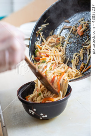 Japanese ramen soup with chicken, egg, chives and sprout on dark wooden background. 48882237