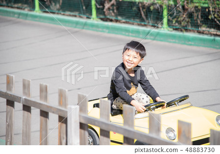 Boys riding a go-kart Boys riding a go-kart 48883730