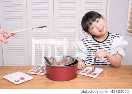 Girl making handmade chocolate Girl making handmade chocolate 48883963