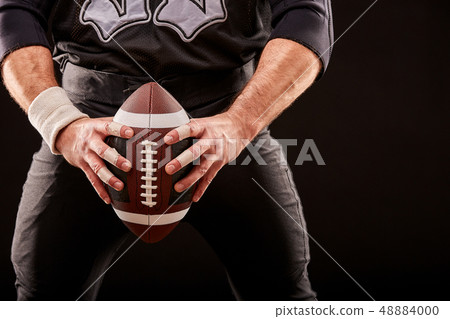 American football sportsman player on stadium with lights on black background. American football sportsman player on stadium with lights on black background. 48884000