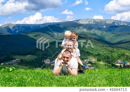 Happy family: joyful father, mother and two sons a Happy family: joyful father, mother and two sons a 48884713