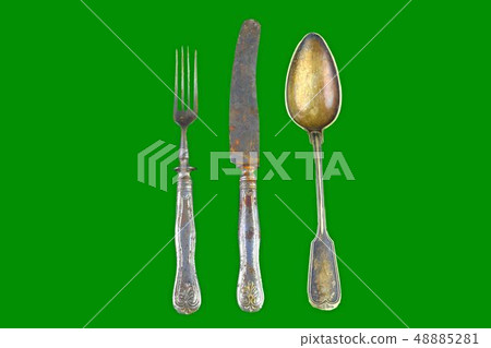 Vintage cutlery on a green background. Top view. Crazy concept for culinary and modern life Vintage cutlery on a green background. Top view. Crazy concept for culinary and modern life 48885281