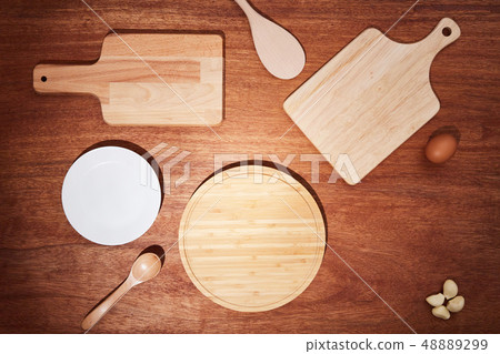 Background with chopping boards and kitchen utensils on a wooden table 48889299