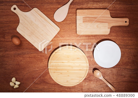 Background with chopping boards and kitchen utensils on a wooden table 48889300