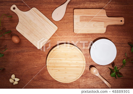 Background with chopping boards and kitchen utensils on a wooden table 48889301