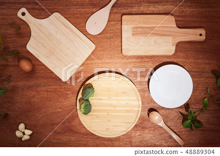 Background with chopping boards and kitchen utensils on a wooden table 48889304