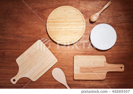 Background with chopping boards and kitchen utensils on a wooden table 48889307