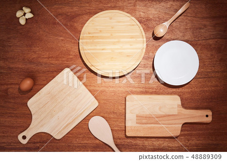 Background with chopping boards and kitchen utensils on a wooden table 48889309