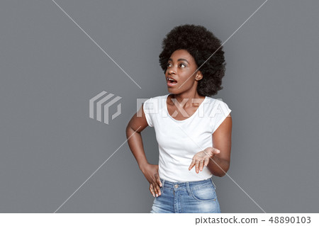 Young woman standing isolated on gray talking concentrated Young woman standing isolated on gray talking concentrated 48890103