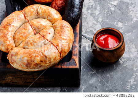 Smoked sausages on cutting board Smoked sausages on cutting board 48892282