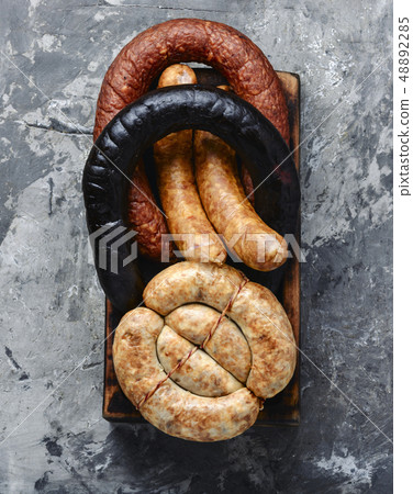 Smoked sausages on cutting board Smoked sausages on cutting board 48892285