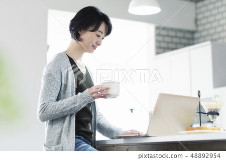 30's Woman Eating Breakfast In Dining Kitchen 30's Woman Eating Breakfast In Dining Kitchen 48892954