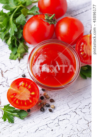Tomato ketchup sauce on wooden background Tomato ketchup sauce on wooden background 48896177