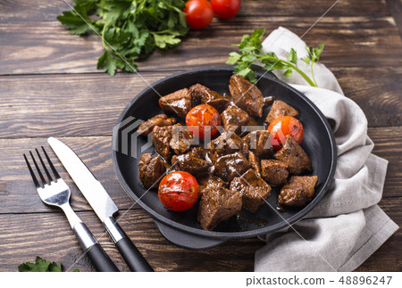 Roasted or stewed beef meat with tomato 48896247