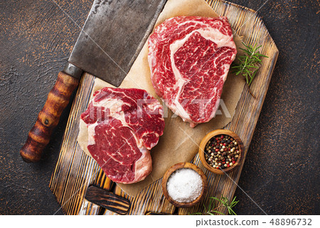 Raw marbled ribeye steak and butchers knife 48896732