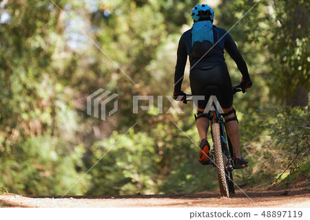 Mountain biking man riding on bike Mountain biking man riding on bike 48897119