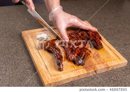 food, delicious and craft concept - Man cutting horse steak food, delicious and craft concept - Man cutting horse steak 48897893