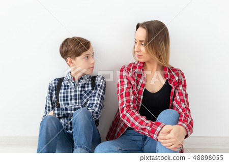 Mothers day, children and family concept - Beautiful woman and her son on white background 48898055