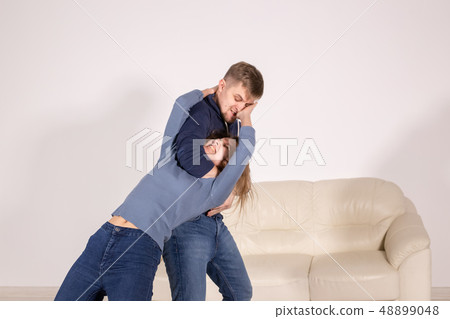 People, abuse and violence concept - aggressive man strangling his wife People, abuse and violence concept - aggressive man strangling his wife 48899048