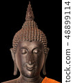 The black buddha statue face on black background  48899114